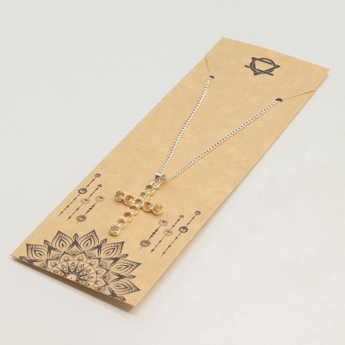 Silver-plated crucifix pendant set with golden citrine-coloured stones, on linen - view 6