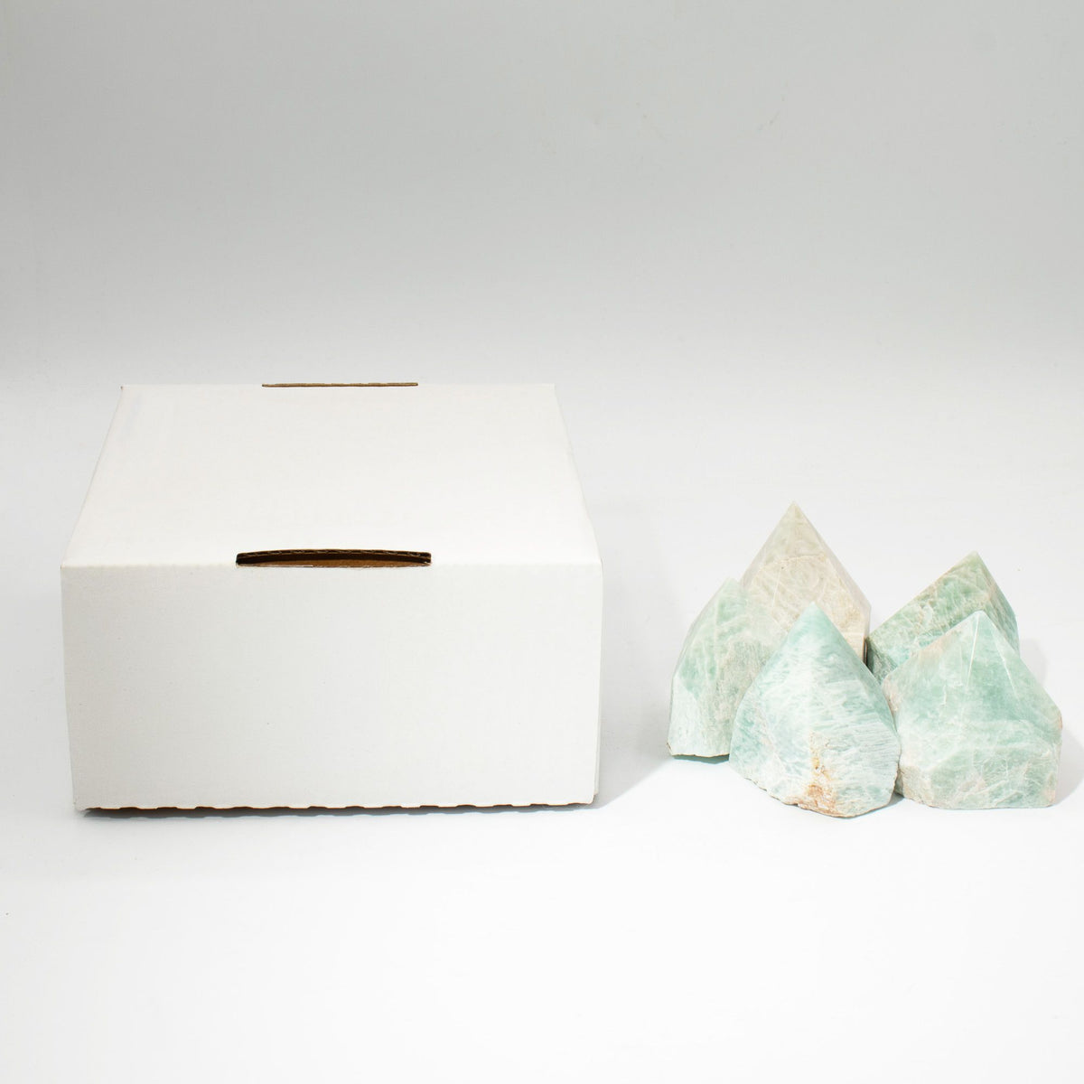 A polished green amazonite crystal point standing on cotton canvas - view 7
