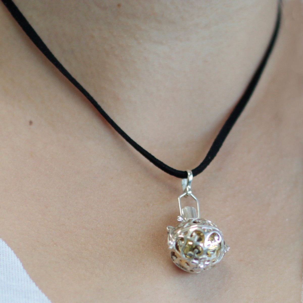 Silver angel bell pendant in the Night-time design on a neck cord