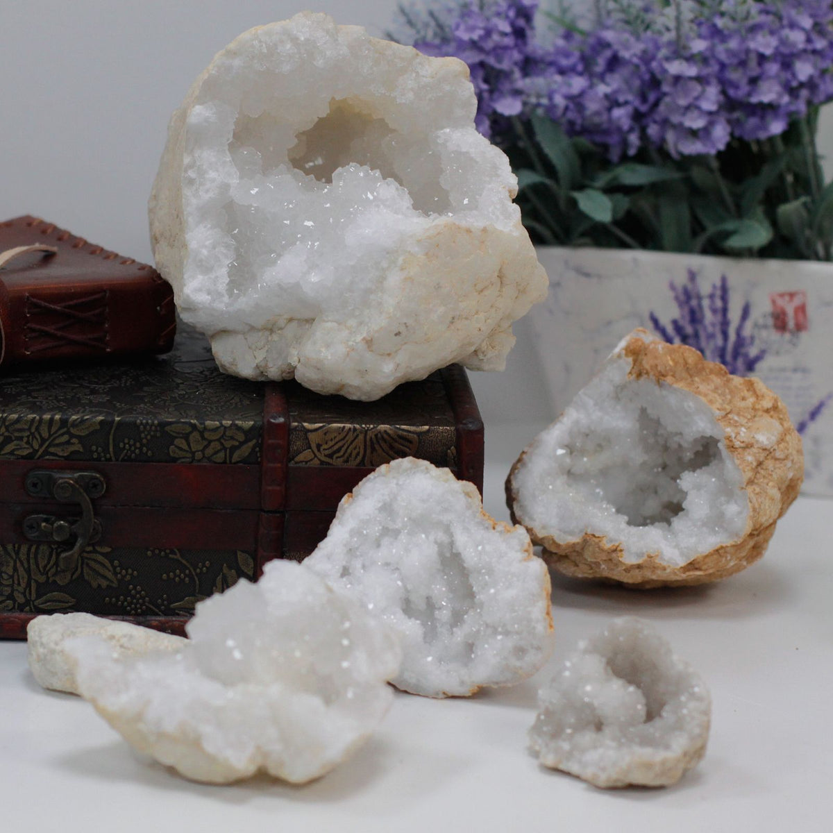 A rough unopened calcite geode resting on cotton-rag paper - view 7