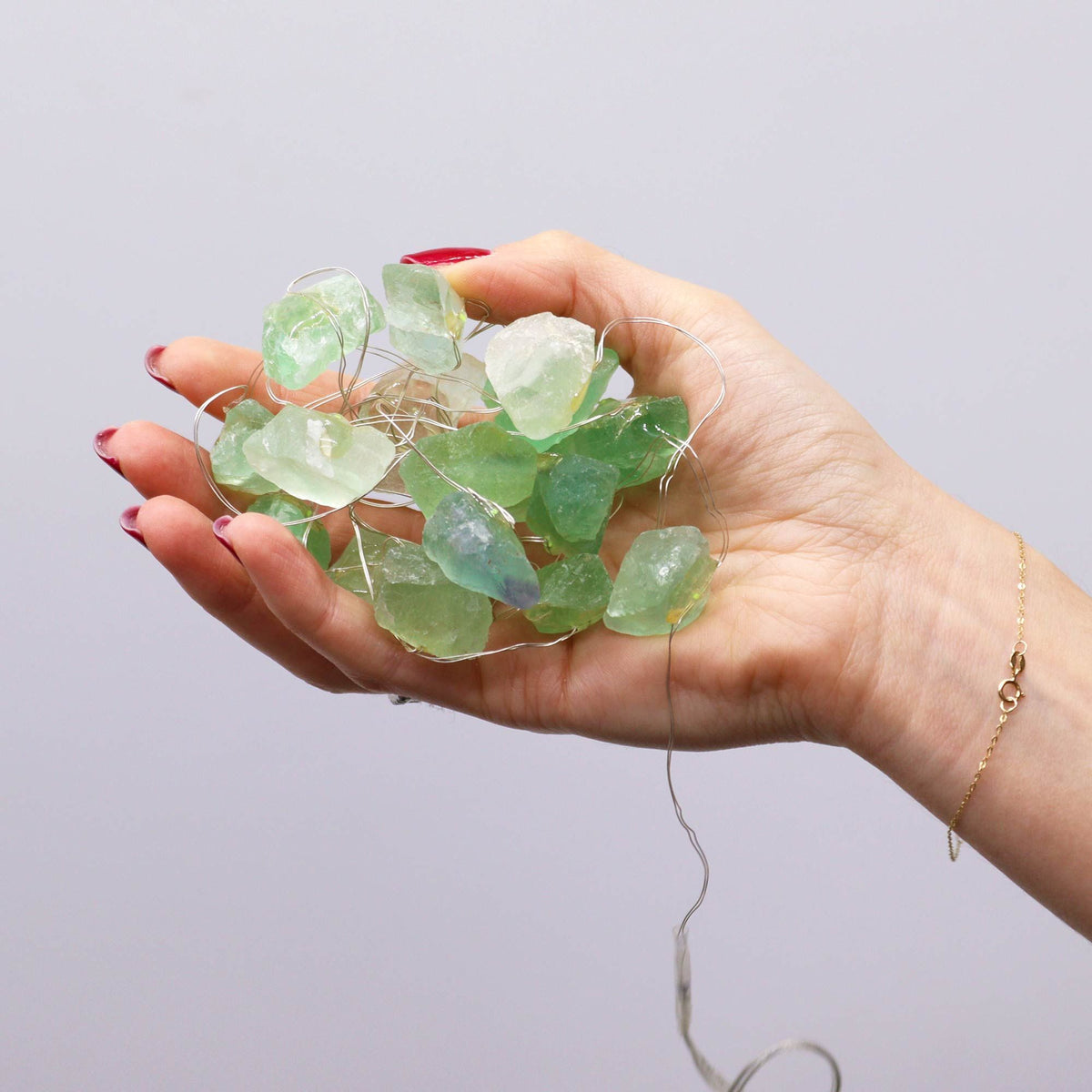 Green crystal jade fairy lights held in a hand