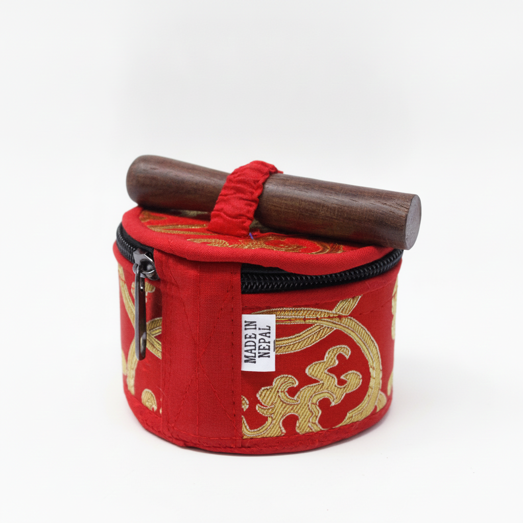 Red brocade carry case for the mini singing bowl with the wooden striker strapped on top