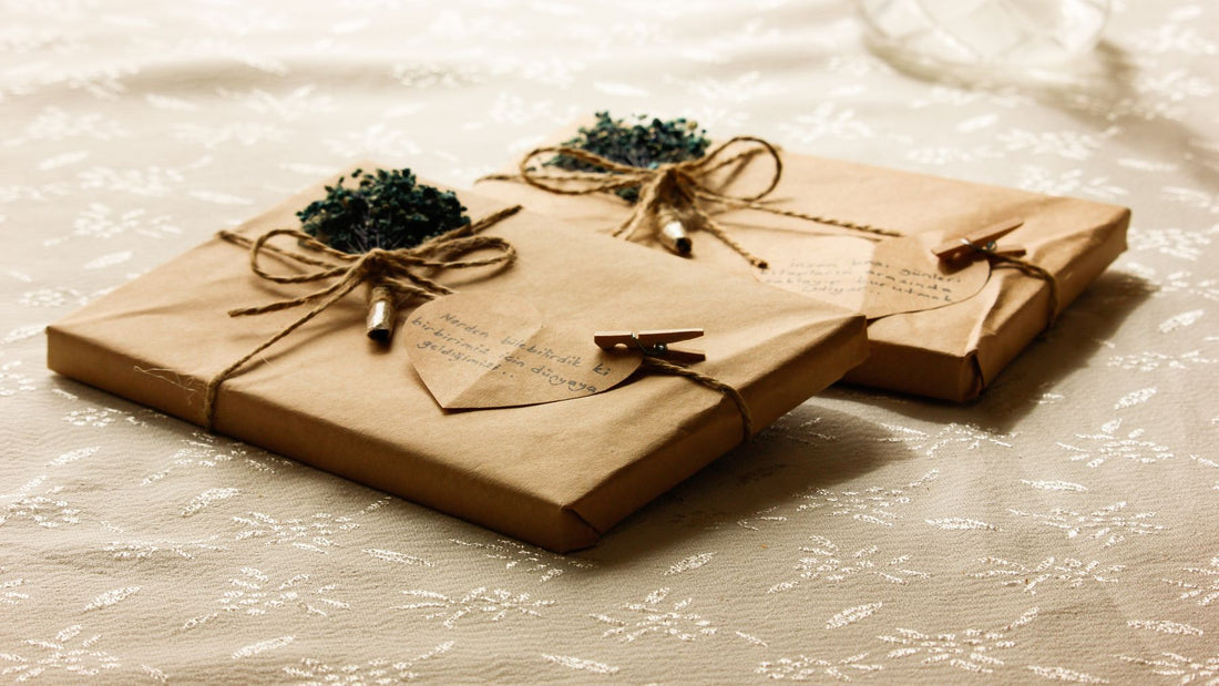 Flat parcels in kraft paper tied with twine and dried flowers