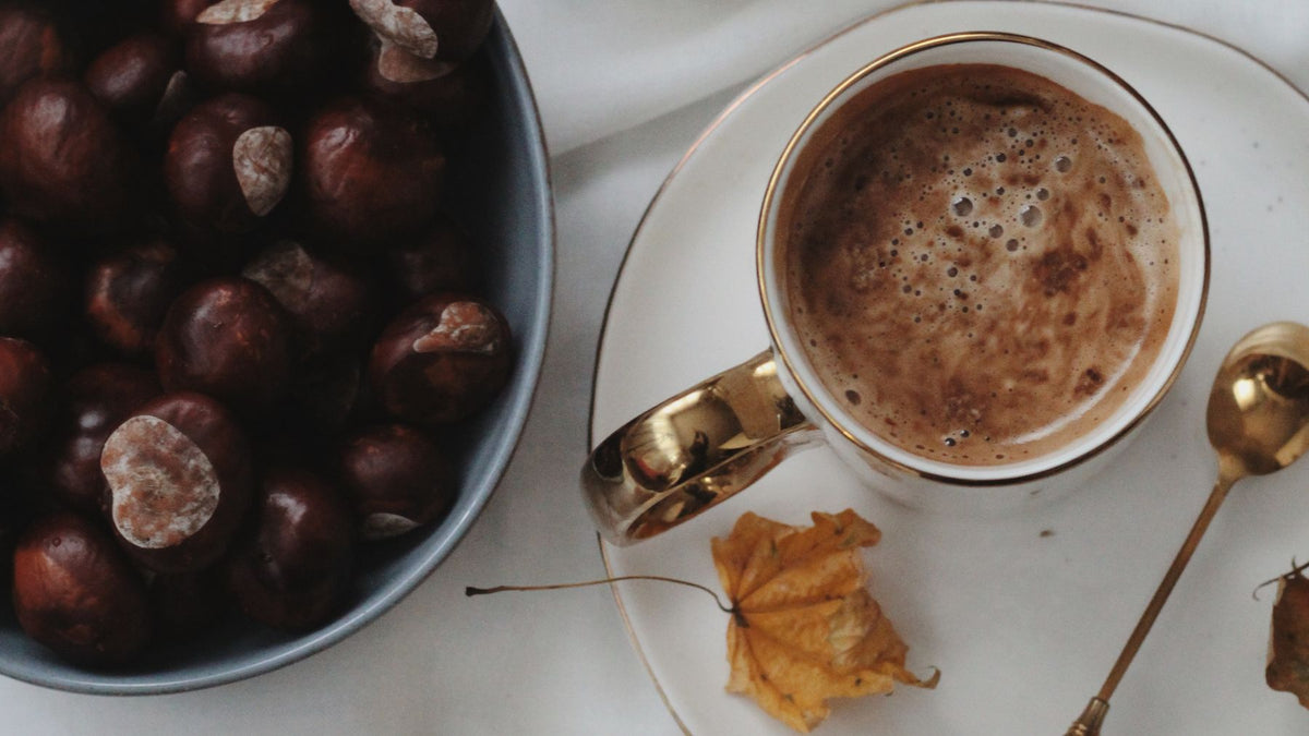 Chestnuts and a warm drink on a table in autumn