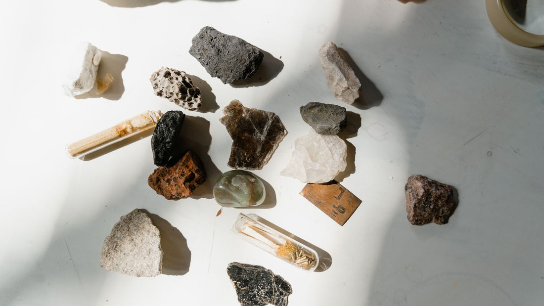 Assorted rough mineral specimens laid out on a white surface
