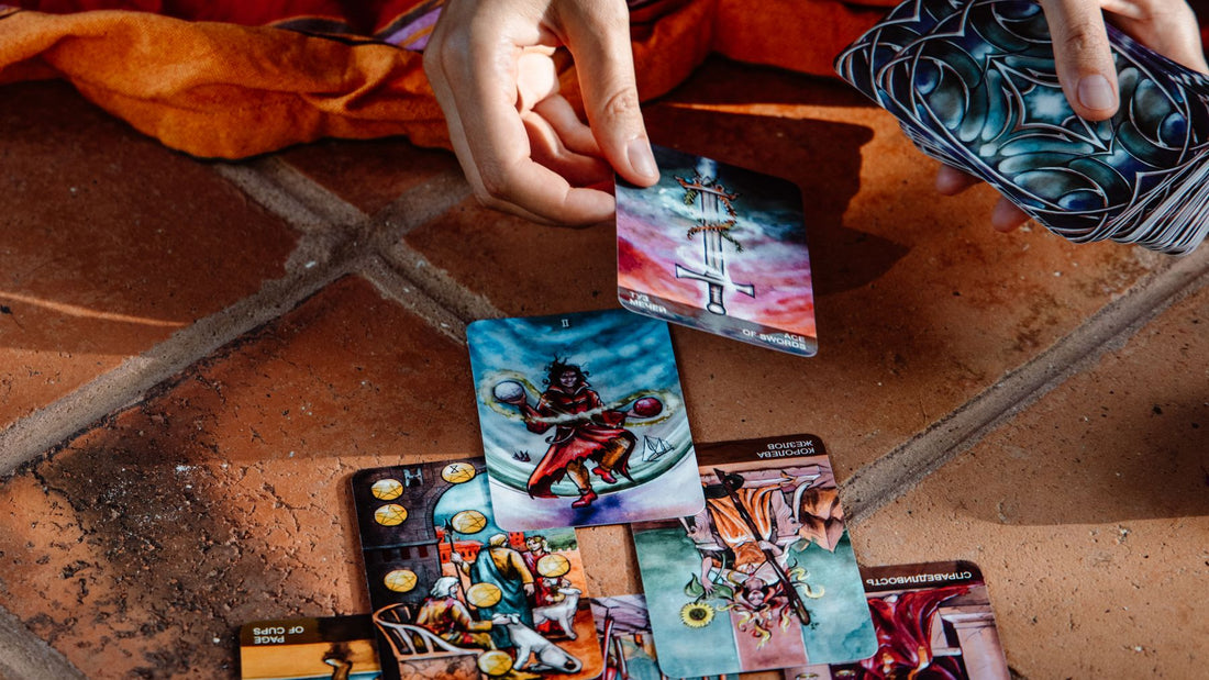 A three-card tarot spread laid out on a tiled floor