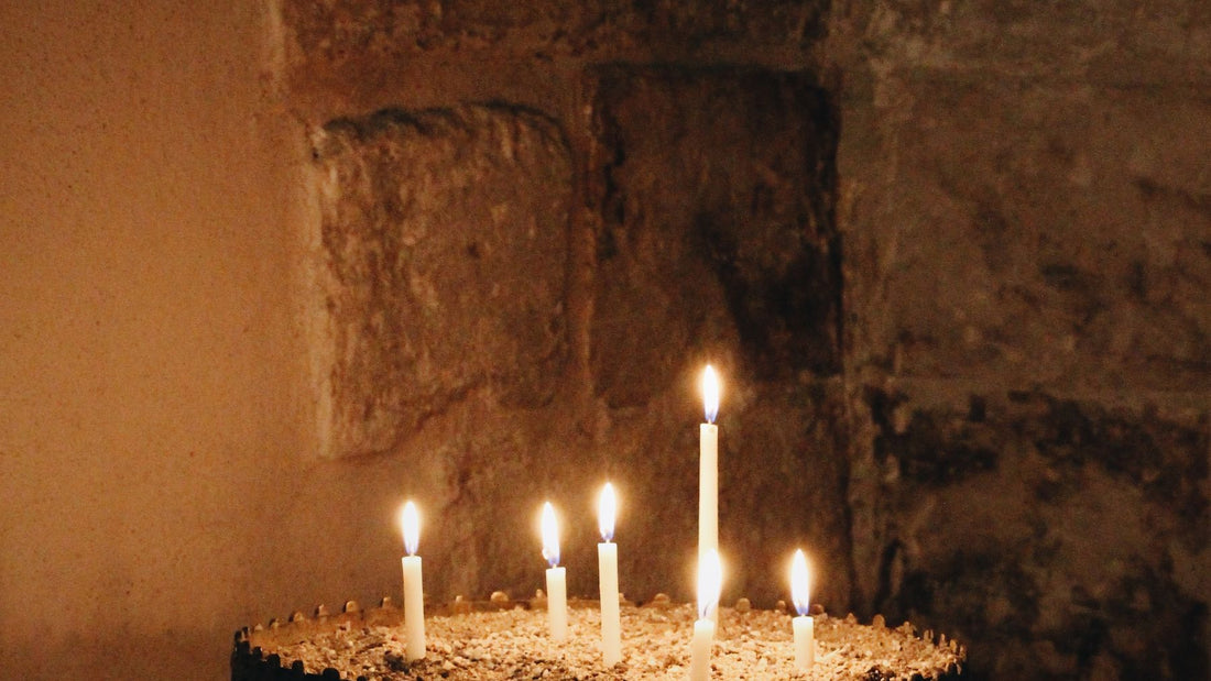 Lit candles in a stone alcove