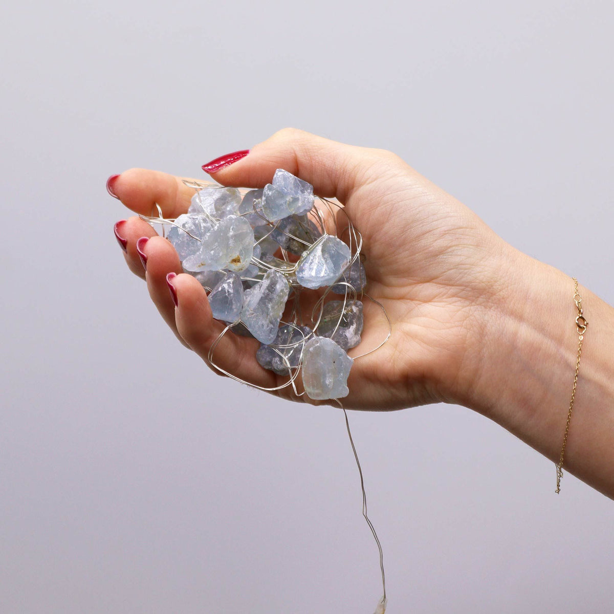 Celestite fairy lights held in a hand
