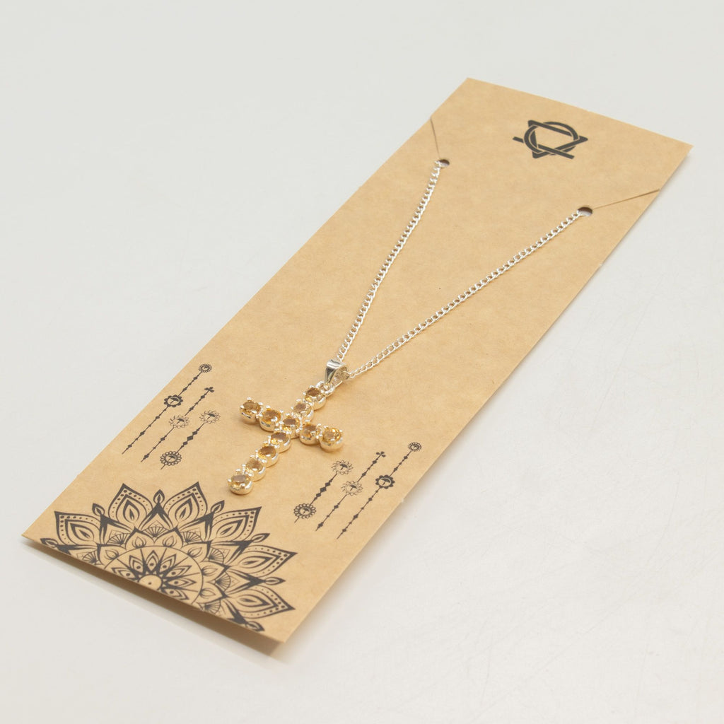 Silver-plated crucifix pendant set with golden citrine-coloured stones, on linen - view 6