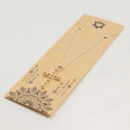 Silver-plated crucifix pendant set with golden citrine-coloured stones, on linen - view 6