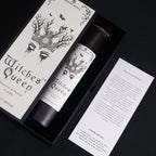 Black Witches' Queen candle tube beside its illustrated box, on cotton canvas - view 6
