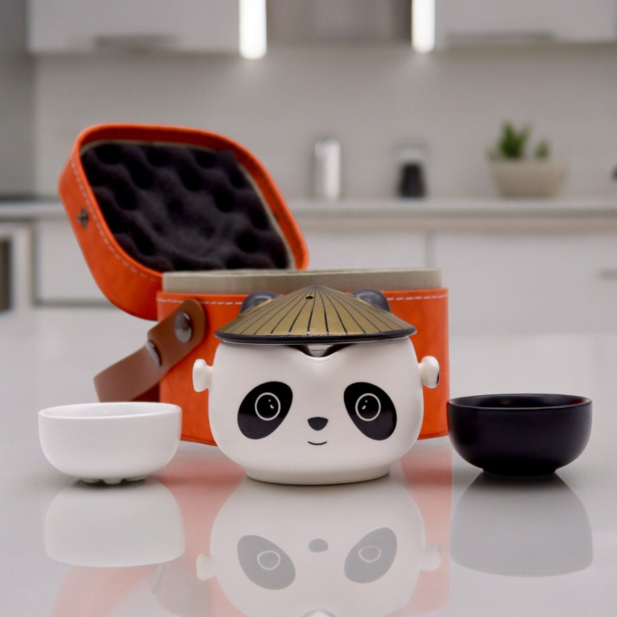 Panda-faced ceramic teapot with two cups and a golden hat lid, on cotton canvas - view 7