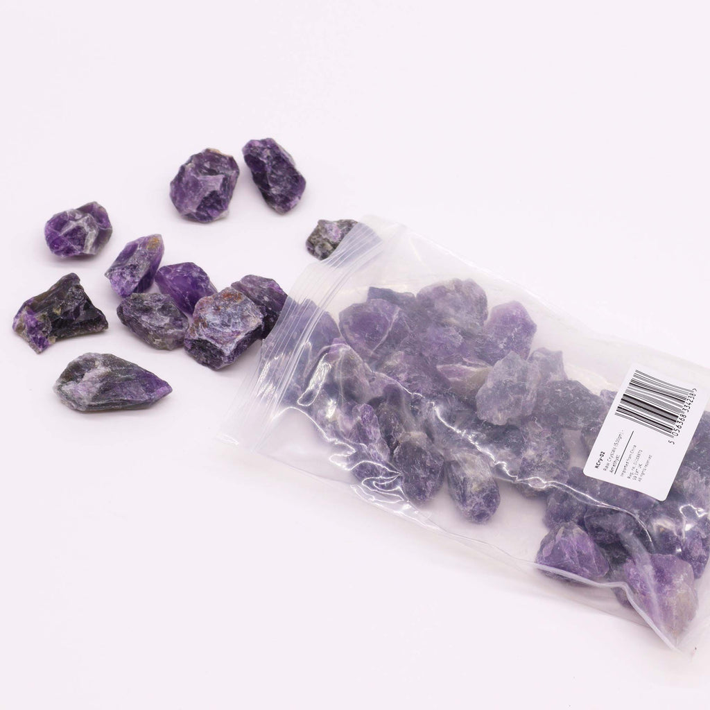 A spread of rough amethyst chunks in deep purple on cotton canvas - view 4