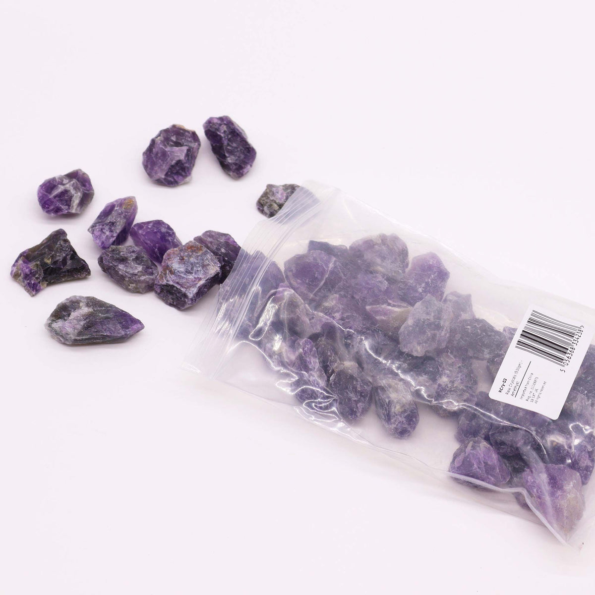 A spread of rough amethyst chunks in deep purple on cotton canvas - view 4