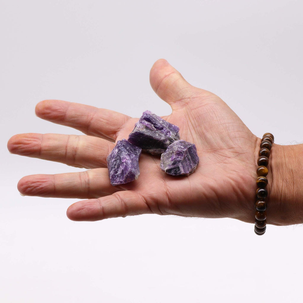 A spread of rough amethyst chunks in deep purple on cotton canvas - view 5