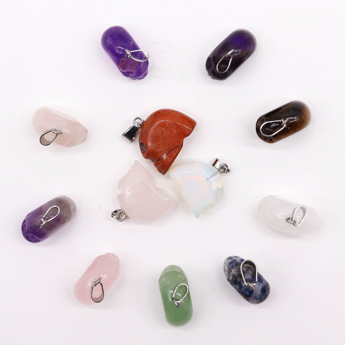 Assorted gemstone mini skull pendants with silver plated bails