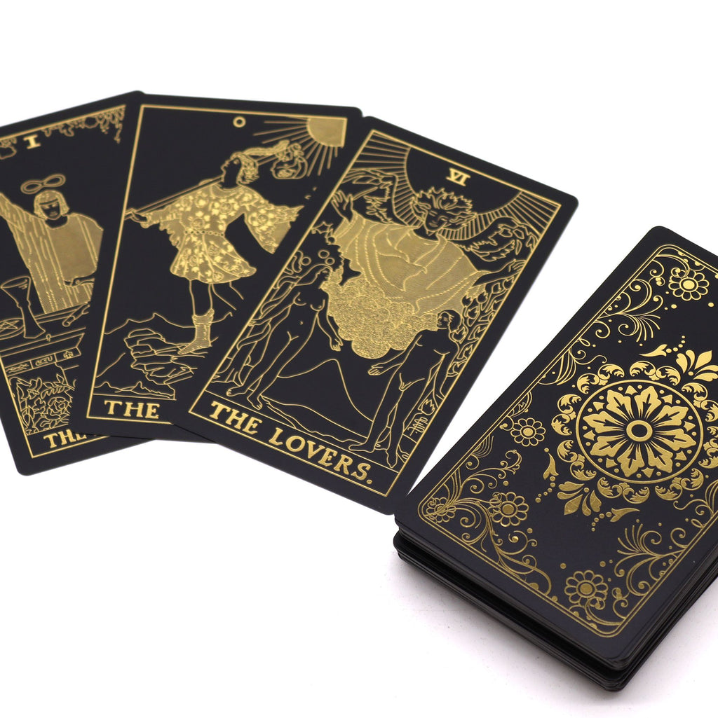 Gold foil tarot deck and guidebook in black and gold foil design
