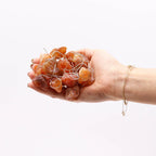 Orange jade fairy lights held in a hand