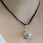 Silver angel bell pendant in the Night-time design on a neck cord