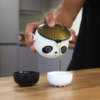Panda-faced ceramic teapot with two cups and a golden hat lid, on cotton canvas - view 6