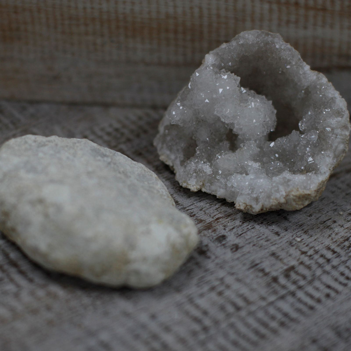 A rough unopened calcite geode resting on cotton-rag paper - view 6