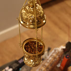 Ornate brass hanging incense burner standing on its footed base, chains beside it - view 4