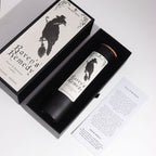 Raven's Remedy candle and spell card in its open gift box