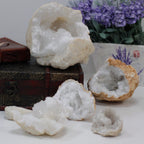 A rough unopened calcite geode resting on cotton-rag paper - view 7