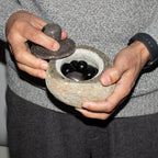 Medium grounding pot carved from a single riverstone, with a fitted stone lid, rough outside and smooth within