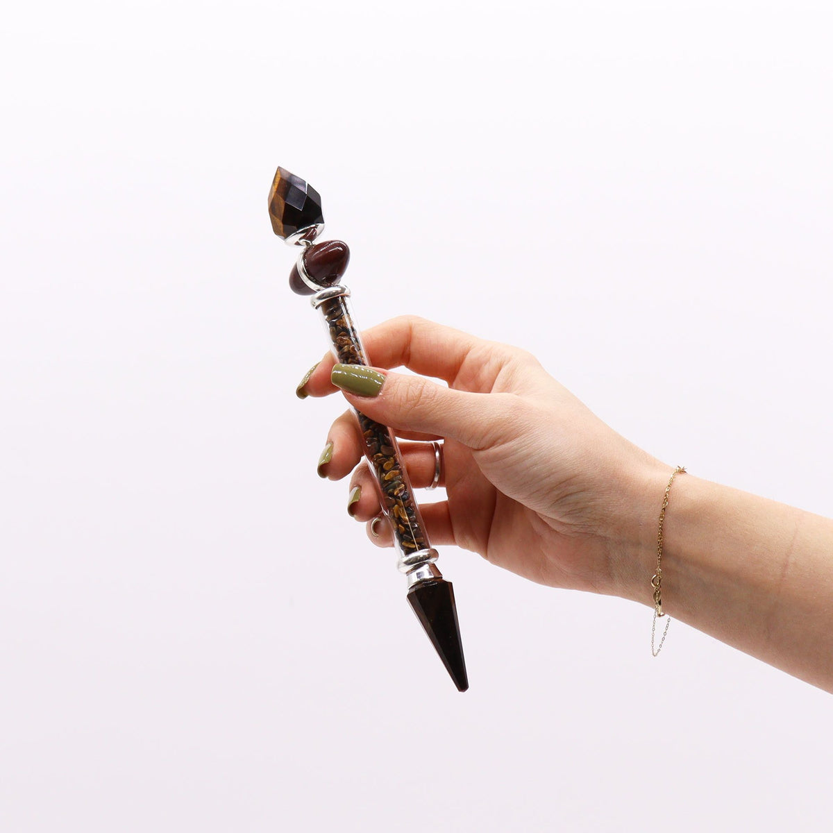 Tiger eye shiva lingam crystal wand with lengthways banding and a faceted point - view 3