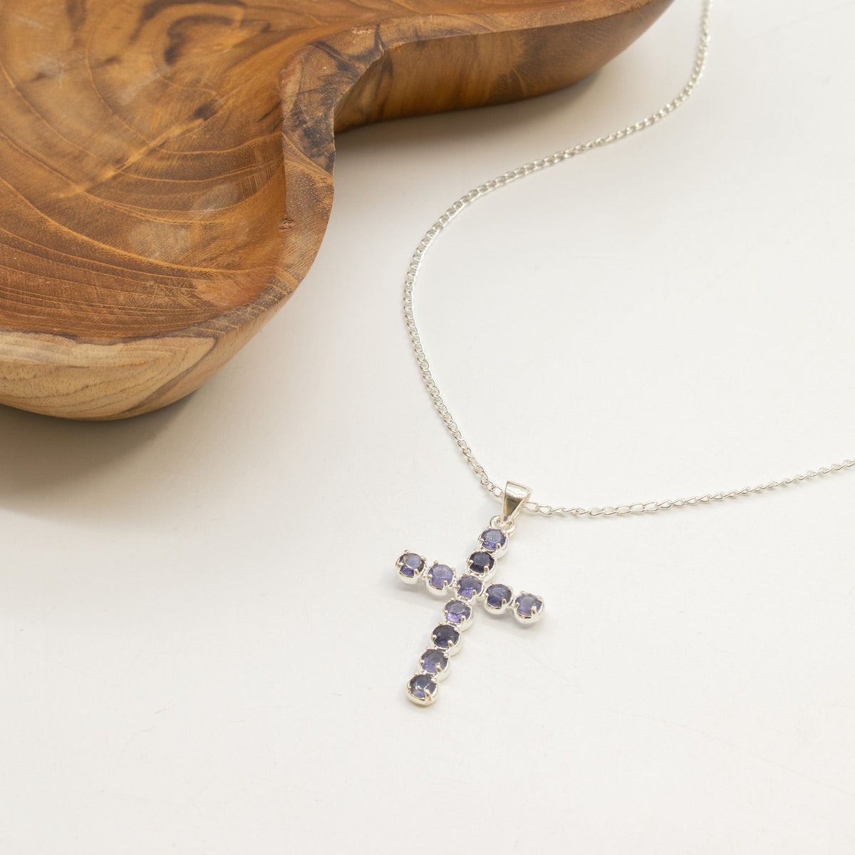 Silver-plated crucifix pendant set with deep purple stones, on linen - view 4