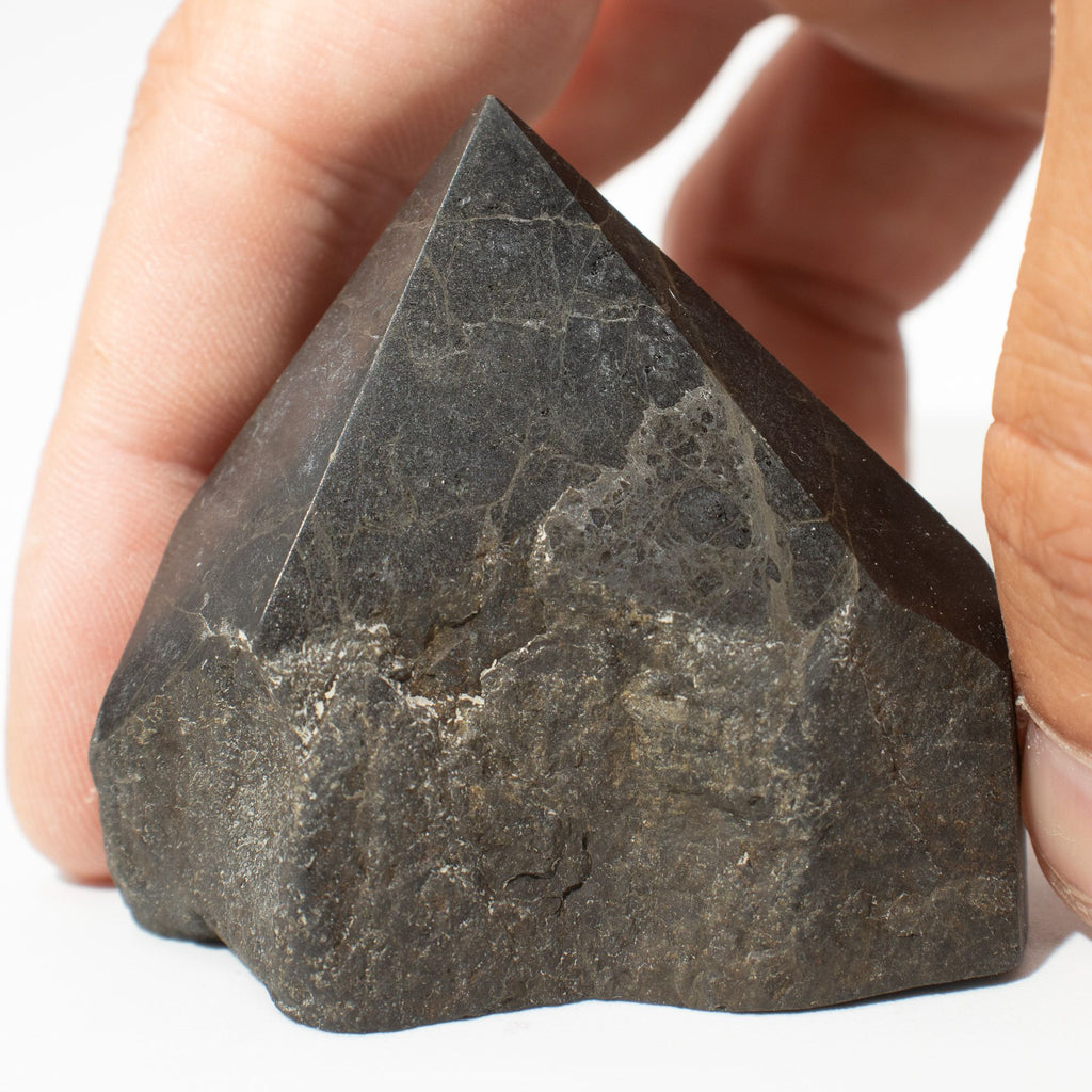 Polished black tourmaline crystal points grouped together on natural linen - view 5