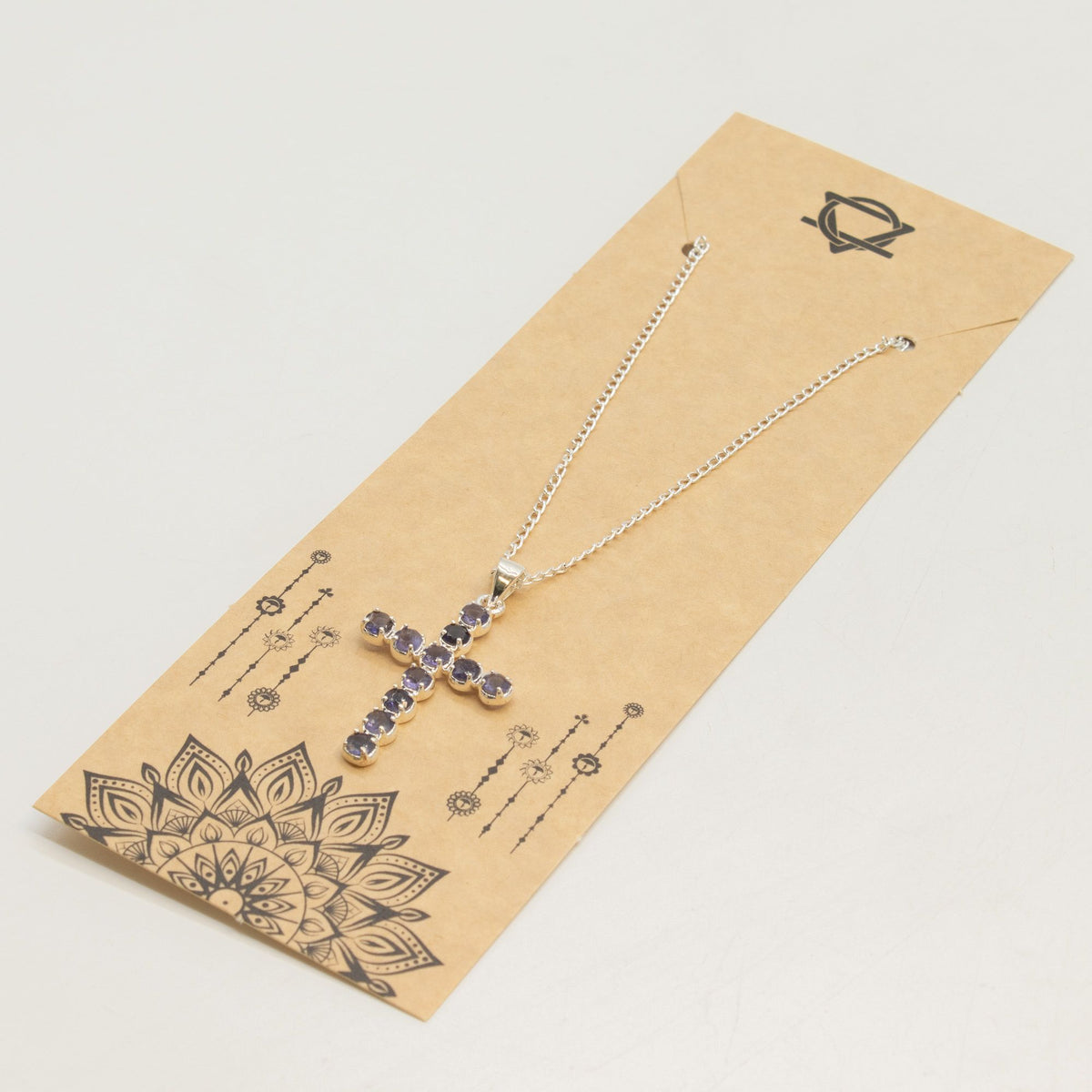 Silver-plated crucifix pendant set with deep purple stones, on linen - view 5