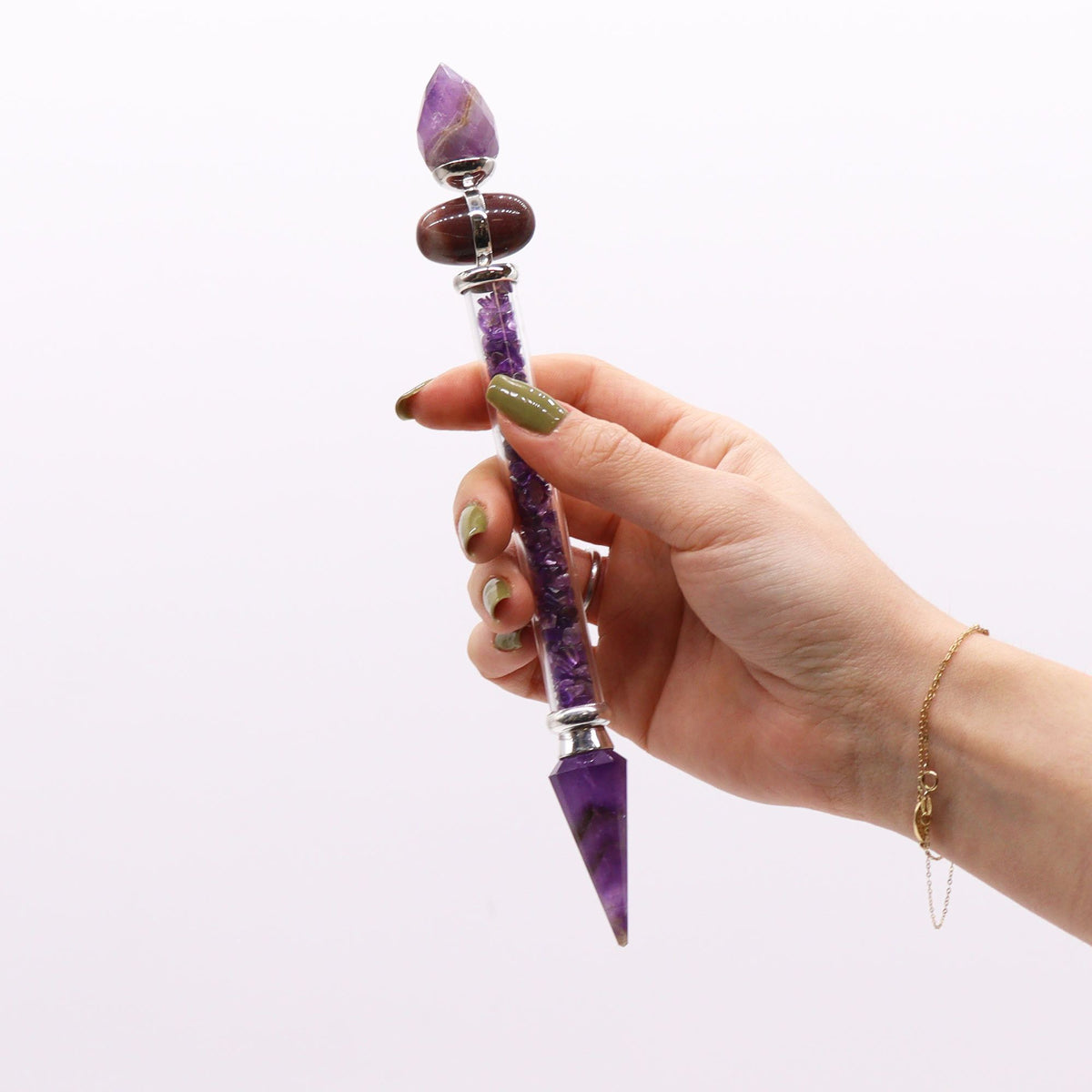 Amethyst shiva lingam wand with silver collars, lying on cotton-rag paper - view 5