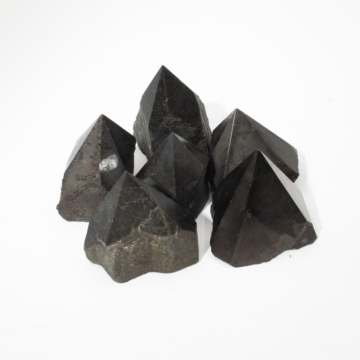 Polished black tourmaline crystal points grouped together on natural linen - view 6