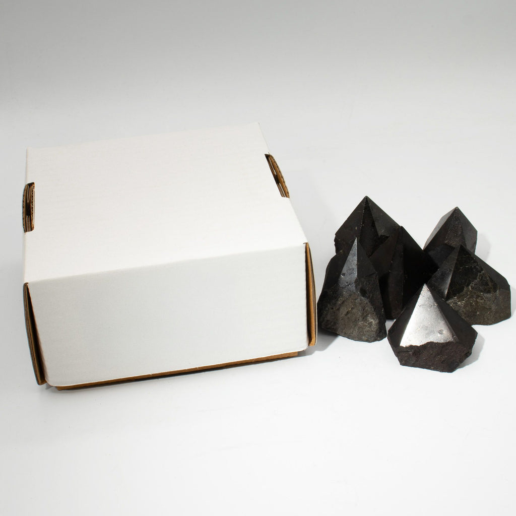 Polished black tourmaline crystal points grouped together on natural linen - view 7