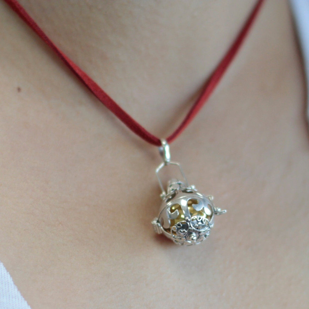 Silver angel bell pendant in the Magic design on a neck cord