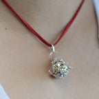 Silver angel bell pendant in the Magic design on a neck cord