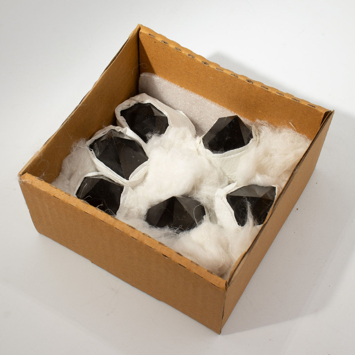 Polished black tourmaline crystal points grouped together on natural linen - view 8