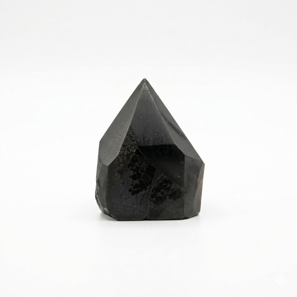 Polished black tourmaline crystal points grouped together on natural linen - view 3