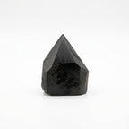 Polished black tourmaline crystal points grouped together on natural linen - view 3