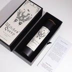 Black Witches' Queen candle tube beside its illustrated box, on cotton canvas - view 5