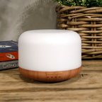Squat white pod aroma diffuser on a wood-effect base - view 2