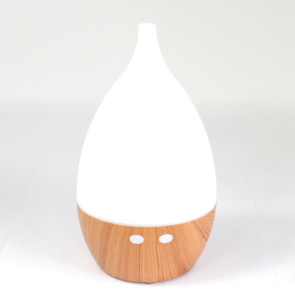 White teardrop ultrasonic aroma diffuser on a light wood base - view 4