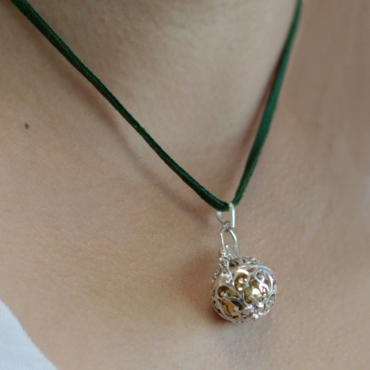Silver angel bell pendant in the Romance design on a neck cord