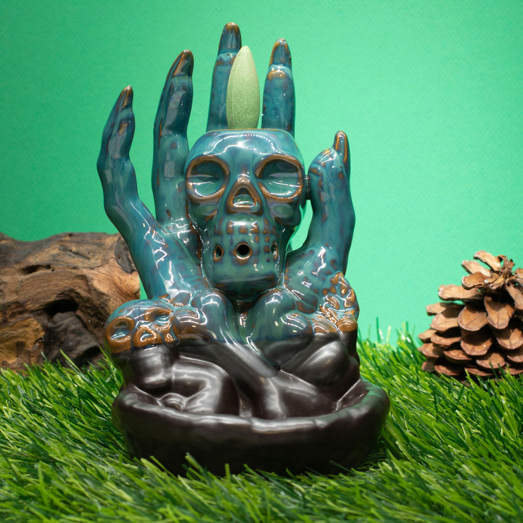 Glazed ceramic backflow burner, a skull cradled in a sculpted hand - view 2