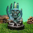 Glazed ceramic backflow burner, a skull cradled in a sculpted hand - view 2