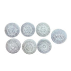 Set of seven small selenite charging plates, one engraved and coloured per chakra - view 2