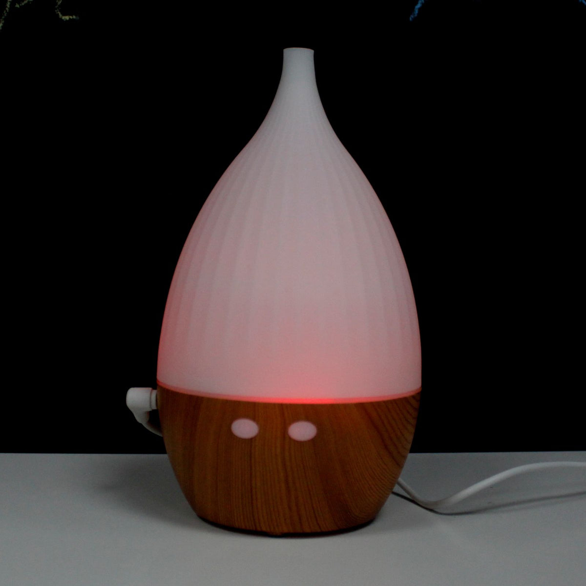White teardrop ultrasonic aroma diffuser on a light wood base - view 5