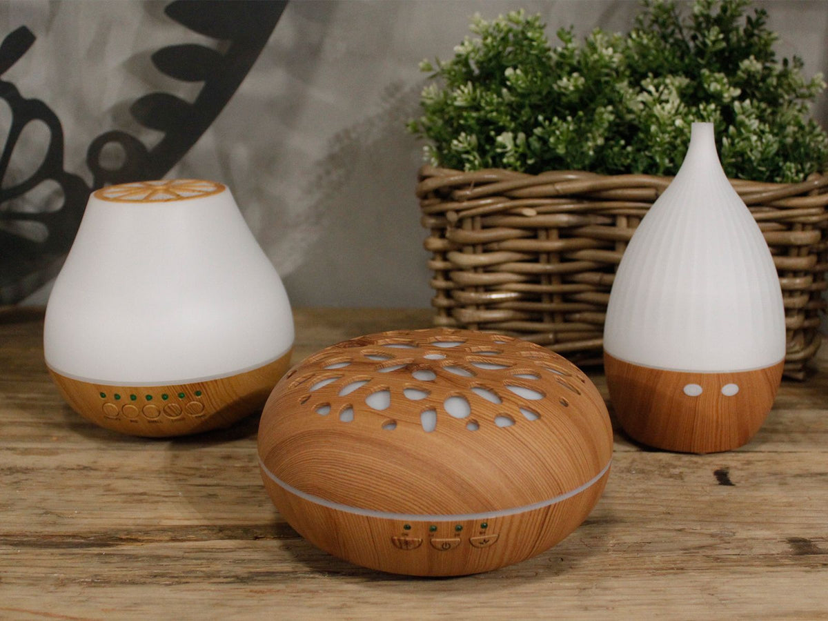 White teardrop ultrasonic aroma diffuser on a light wood base - view 6